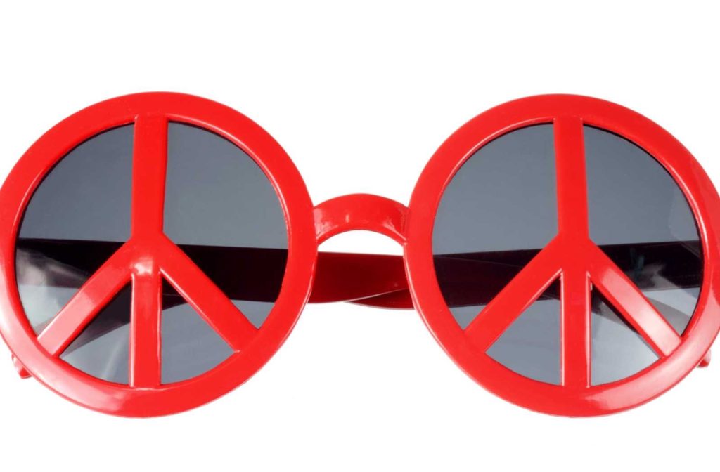 bright red peace-sign novelty sunglasses with grey lenses on a white background